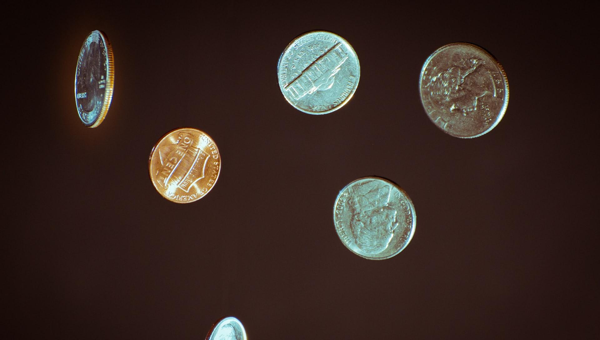 silver round coins on white surface